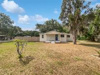 Charming single-story home featuring a well-maintained lawn and inviting blue door at 2845 Ellis Ave, Lakeland, FL 33803