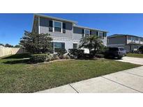 Charming two-story home with blue siding, manicured lawn, and a paved driveway at 439 Sunfish Dr, Winter Haven, FL 33881