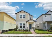 Charming two-story home features a welcoming front porch and beautiful landscaping at 4545 Cross Prairie Pkwy, St Cloud, FL 34772