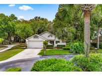 Charming single-Gathering home featuring a well-maintained lawn and mature landscaping at 600 Fallsmead Cir, Longwood, FL 32750