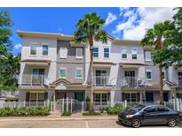 Charming multi-story townhome with a well-manicured lawn and a classic white picket fence at 810 Greybull Run, Lake Mary, FL 32746