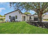 Inviting home exterior featuring a manicured lawn, modern design, and dark accents at 1365 Lake Dr, Casselberry, FL 32707