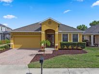 Charming single-story home with a well-maintained lawn and colorful landscaping at 2142 Victoria Dr, Davenport, FL 33837