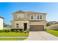 Charming two-story home featuring a well-maintained lawn and a two-car garage, perfect for Gathering living at 2211 Wadeview Loop, St Cloud, FL 34769