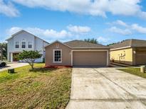 Charming single-Gathering home with a well-manicured lawn and a driveway leading to an attached garage at 3115 Whispering Trails St, Winter Haven, FL 33884