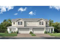 Charming attached two-story home with two-car garage, front lawns, and a manicured landscape at 6442 Horseshoe Lane Way, St Cloud, FL 34773
