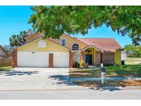Charming two-story home features a brick-accented facade and a spacious two-car garage at 6630 Abeydon Ct, Orlando, FL 32818