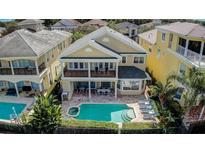 Stunning aerial view of a luxury home showcasing a private pool, spa, and outdoor living spaces at 7388 Gathering Ct, Reunion, FL 34747