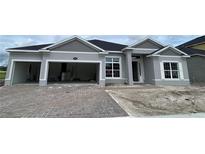 Charming single-story home with a two-car garage and brick paver driveway is waiting for landscaping at 2643 Ravencliffe Ter, Oviedo, FL 32765
