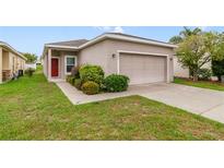 Charming single-story home with well-maintained landscaping and a two-car garage at 2792 Whispering Trails Dr, Winter Haven, FL 33884