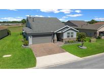 Beautiful single Gathering home with a well-manicured lawn and paver driveway at 4687 Nw 35Th Lane Rd, Ocala, FL 34482
