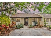 Charming home featuring lush landscaping, mature trees, and a welcoming entrance at 512 Derby Dr, Altamonte Springs, FL 32714