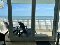 Relaxing balcony with Adirondack chairs and a stunning ocean view at 5203 S Atlantic Ave # 416B, New Smyrna Beach, FL 32169