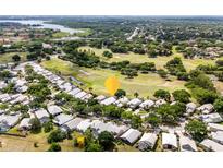 An aerial view of a home with a golf course community and mature trees at 7264 Hawksnest Blvd, Orlando, FL 32835