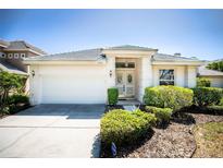 Charming single-story home featuring a manicured lawn and a two-car garage at 7264 Hawksnest Blvd, Orlando, FL 32835