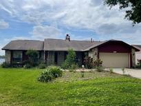 Charming single-story home with stone accents and a well-manicured front yard at 8129 Granada Blvd, Orlando, FL 32836