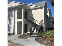Exterior view of two story condo building with stairs leading up to the units at 1055 S Hiawassee Rd # 2018, Orlando, FL 32835