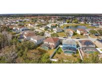 Aerial view of the neighborhood, highlighting a home with a screened-in pool, nestled within a Gathering-friendly community at 1176 Liberty Hall Dr, Kissimmee, FL 34746