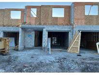 A new construction townhouse featuring a concrete block foundation and wood framing during the building process at 14910 Harvest St, Orlando, FL 32824