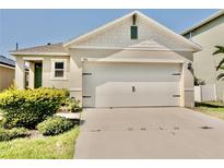 Charming single-Gathering home features a two-car garage and well-maintained landscaping at 156 Eagleview Loop, Davenport, FL 33837