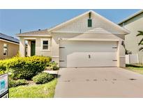 Charming one-story home with a two-car garage and well-maintained landscaping at 156 Eagleview Loop, Davenport, FL 33837
