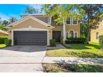 Inviting two-story home with a well-manicured lawn and a two-car garage at 1563 Song Sparrow Ct, Sanford, FL 32773