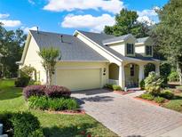 Charming single-Gathering home boasting mature landscaping and a brick-paved driveway leading to an attached two-car garage at 1626 Victoria Gardens Drive, Deland, FL 32724