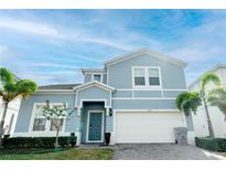 Charming two-story home featuring a well-manicured lawn and a two-car garage at 2123 Lelani Cir, Davenport, FL 33897