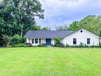 Charming one-story home with a well-manicured lawn and colorful landscaping at 29540 Deerwood Farms Rd, Sorrento, FL 32776