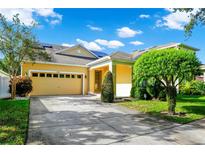 Charming single-Gathering home featuring a two-car garage, well-maintained lawn, and mature landscaping at 11718 Fitzgerald Butler Rd, Orlando, FL 32836