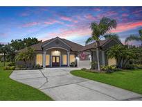 Stunning single-story home with lush landscaping, a wide driveway, and a charming front porch at 128 Hallstrom Ct, Debary, FL 32713