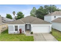 Charming single-story home with a well-maintained lawn and attached two-car garage, offering curb appeal at 252 Elgin Blvd, Davenport, FL 33897