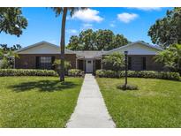 Charming brick home with a well-manicured lawn and lush landscaping at 2532 Waterview Pl, Windermere, FL 34786