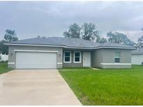 Charming single-story home with a well-manicured lawn and attached two-car garage at 3389 Sw 126Th Lane Rd, Ocala, FL 34473