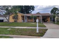 Charming single-story home with a well-maintained lawn and covered carport at 4619 Salvia Dr, Orlando, FL 32839