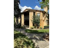 Exterior shot of a well-maintained condo, showcasing its architecture and verdant surroundings at 4800 S Semoran Blvd # 101, Orlando, FL 32822