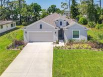 Charming single-story home features a manicured lawn, two-car garage, and neutral exterior paint at 1314 Victory Palm Dr, Edgewater, FL 32132