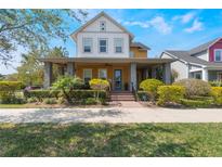 Charming two-story home with a cozy front porch and meticulously manicured landscaping at 13798 Walcott Ave, Orlando, FL 32827