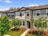 Charming townhome with a well-maintained lawn, sidewalk, and tasteful exterior color scheme at 3039 Springwell Loop, Orlando, FL 32808