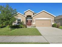 Charming single-Gathering home with a well-maintained lawn and inviting curb appeal at 1052 Cascade Dr, Davenport, FL 33837