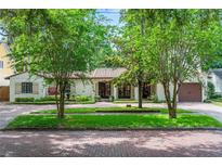 Charming single-story home with lush landscaping, brick street, and Spanish tile roof at 1110 Greenwood St, Orlando, FL 32801