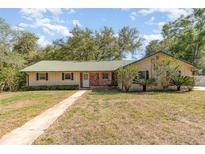 Charming single-story home with a metal roof and a well-maintained front yard at 360 Westchester Dr, Deland, FL 32724