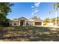 Charming single-story home featuring a manicured lawn, covered entryway, and a two-car garage at 814 Vercelli St, Deltona, FL 32725