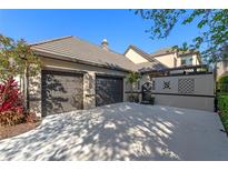 Inviting home exterior with two-car garage, driveway, and lush landscaping, perfect for curb appeal at 9624 Bryanston Dr, Orlando, FL 32827