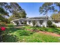 Charming single-story home with a well-maintained lawn and mature trees at 228 Deleon Rd, Debary, FL 32713