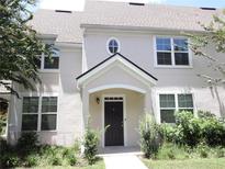 Charming townhome exterior features a well-manicured lawn and inviting entrance with a black front door at 3364 Westchester Square Blvd # 204, Orlando, FL 32835