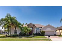 Charming single-story home with stone accents, manicured lawn, and lush landscaping, creating an inviting curb appeal at 3436 Herringridge Dr, Orlando, FL 32812