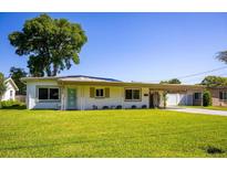 Charming single-story home featuring a lush front lawn and a covered carport for convenient parking at 605 Oranole Rd, Maitland, FL 32751