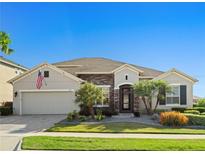Charming one-story home featuring stone accents, manicured landscaping, and a well-maintained lawn at 970 Timberview Rd, Clermont, FL 34715
