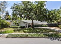 Charming single-story home featuring a lush front yard, mature trees, and a covered entrance at 2004 Mohawk Trl, Maitland, FL 32751